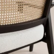 Close-up of Cane Sculpt Armchair natural cane weave and white upholstered seat