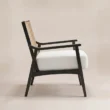 Side view of Cane Sculpt Armchair showing open wooden arms and white cushioned seat