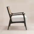 Side view of Cane Sculpt Armchair showing open wooden arms and white cushioned seat