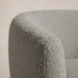 Close-up of the textured grey upholstery and curved arm seam