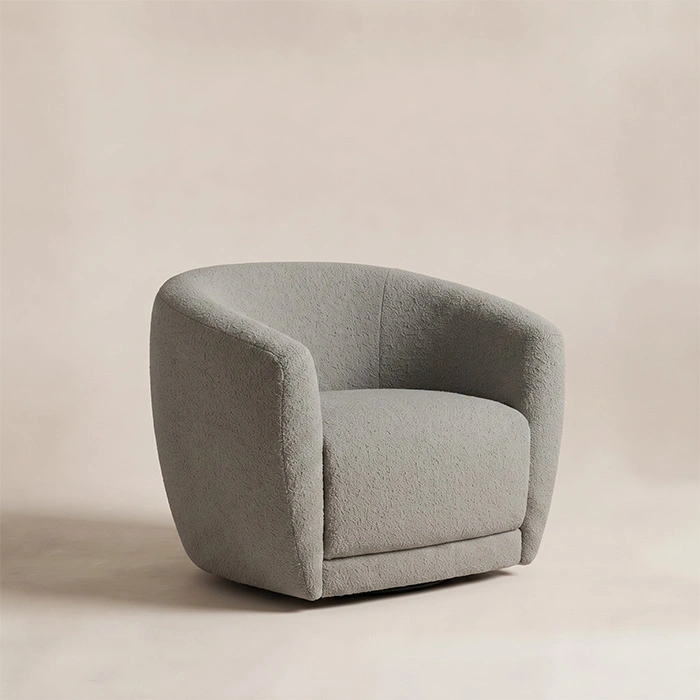 CreamCove curved armchair in grey shown from a three-quarter angle
