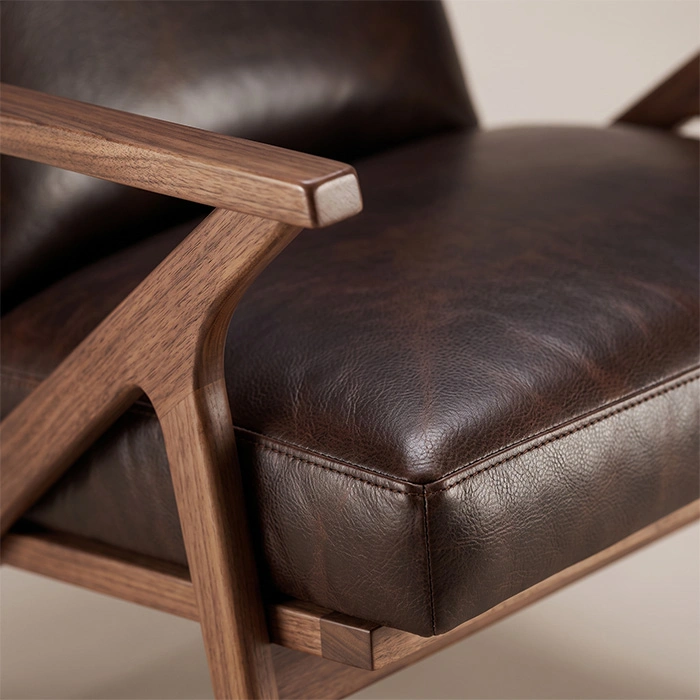 fiora-mid-century-armchair-dark-brown-closeup-detail-view. Close-up of Fiora armrest, wood frame and dark brown upholstered seat