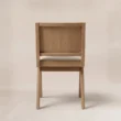 Back view showing the chair’s exposed wood frame and clean rear profile