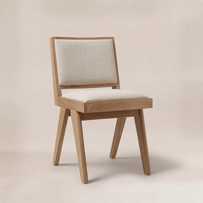 Noble upholstered dining chair in a light wood finish with cream seat and back