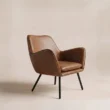 Rear three-quarter view of Varden Lounge Armchair showing its sculpted upholstered shell and metal legs