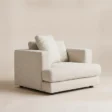 Velora Soft Armchair in white upholstery with wide arms and loose back cushions, angled view