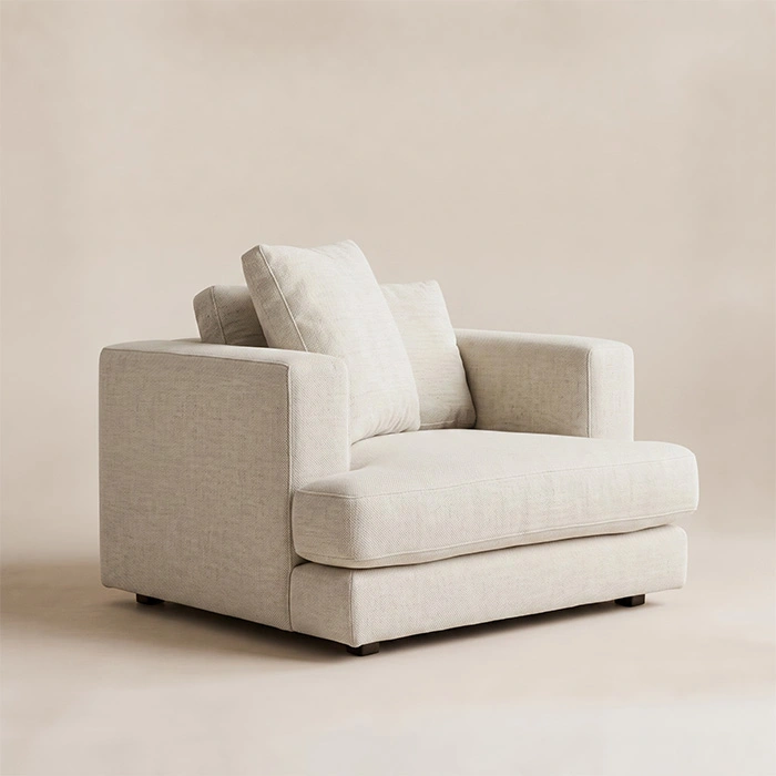 Velora Soft Armchair in white upholstery with wide arms and loose back cushions, angled view