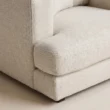 Close-up of Velora Soft Armchair white textured upholstery, seat cushion and upholstered arm