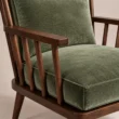 Close-up of the wooden arm, spindle detailing and textured striped upholstery