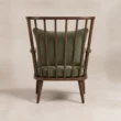 Rear view showing the open spindle back and curved wooden top rail