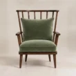 Front view of the Windsor Nest spindle armchair with striped upholstered cushions
