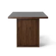 side profile view showing flutted pannel of table