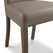 close view showing chair seat upholstery and wooden legs