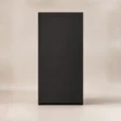 Rear view of the tall matte-black Tressel wardrobe