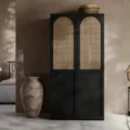 Black cane wardrobe styled in a bedroom, arched rattan doors, compact 100cm wardrobe storage.