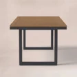 Rectangular outdoor dining table with warm wood top and dark frame