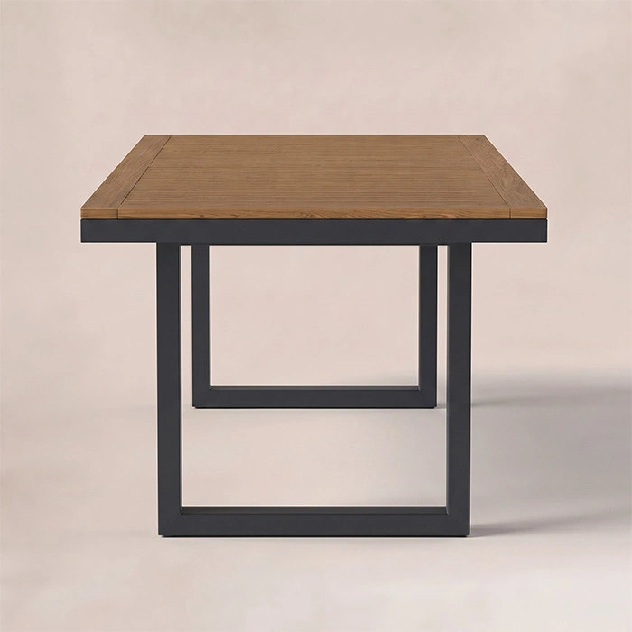 quartz-outdoor-dining-table-front-view. Rectangular outdoor dining table with warm wood top and dark frame