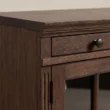 Close-up of Oak detailing, moulded edge, drawer front, and cabinet hinge.