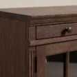 Close-up of Oak detailing, moulded edge, drawer front, and cabinet hinge.