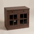 Three-quarter view of the Brown Wash glass door cabinet with drawer and interior shelf.