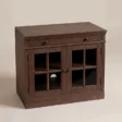 Three-quarter view of the Brown Wash glass door cabinet with drawer and interior shelf.