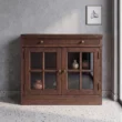 Brown Wash glass door cabinet styled with pottery in a contemporary interior.