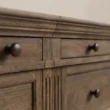 Close-up of Brown Wash finish, fluted detailing and metal hardware on Stalwart Media Console