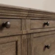 Close-up of Brown Wash finish, fluted detailing and metal hardware on Stalwart Media Console