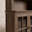 Close-up of Oak framing, moulded detailing, and glass-front cabinet construction.