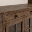Close-up of Oak grain, framed drawer front, and antique-style metal knob.