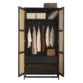Open doors of the black rattan wardrobe showing the metal hanging rail and internal shelves.