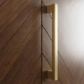 wardrobe brass door handle close up on walnut herringbone panel