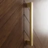 wardrobe brass door handle close up on walnut herringbone panel