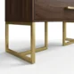 Brunel wardrobe gold metal base close up with walnut cabinet edge