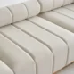 Close-up of brown resin wicker texture and beige cushion.