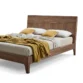 angled view of wooden bed in white background