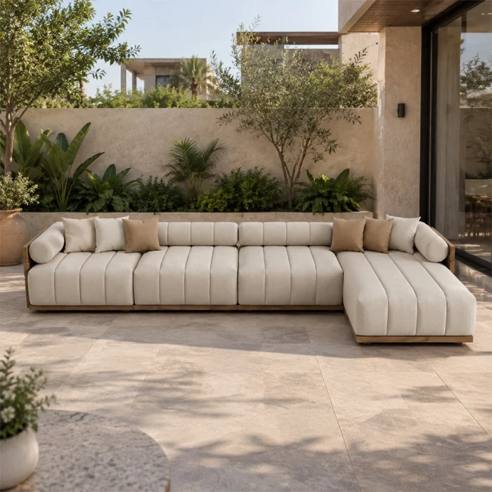 Fjord modular outdoor sofa with ivory upholstery in a landscaped patio setting