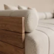 Close-up of textured upholstery and solid wood arm detailing
