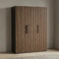 Graino modern fluted wooden wardrobe elegantly styled in a contemporary master bedroom setting.