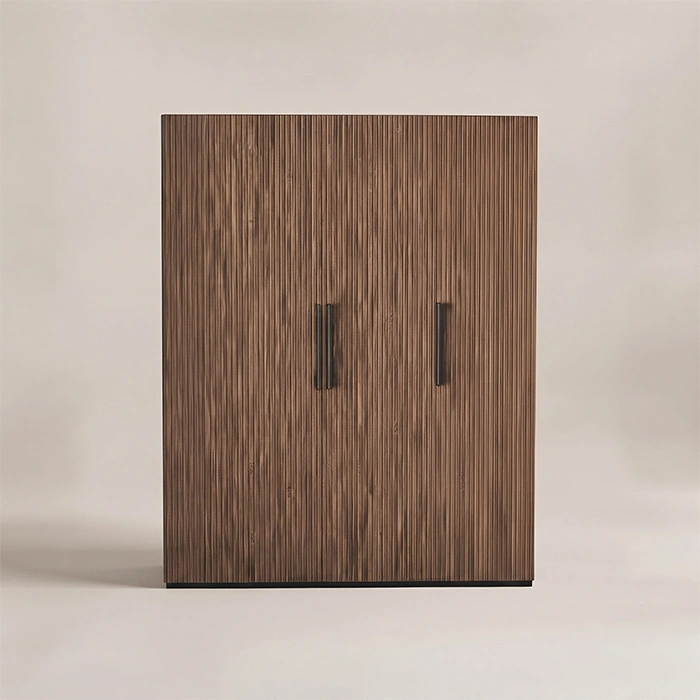 Front view of fluted wooden wardrobe with walnut-toned doors and black handles
