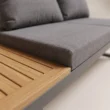 Close-up of grey cushion beside solid teak slatted detailing