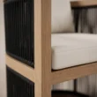 Close-up of Wharf chair showing dark rope weaving, wood frame and seat cushion