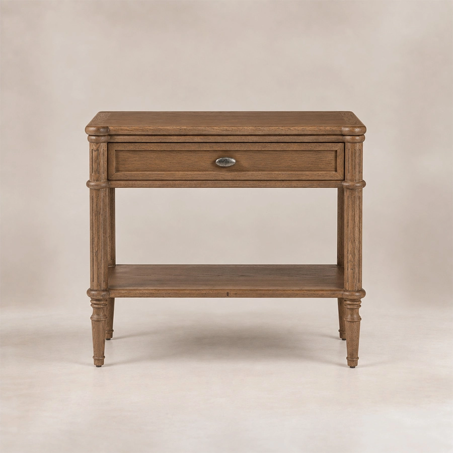Aldren wooden bedside table with single drawer, open shelf, warm brown finish, and turned legs.