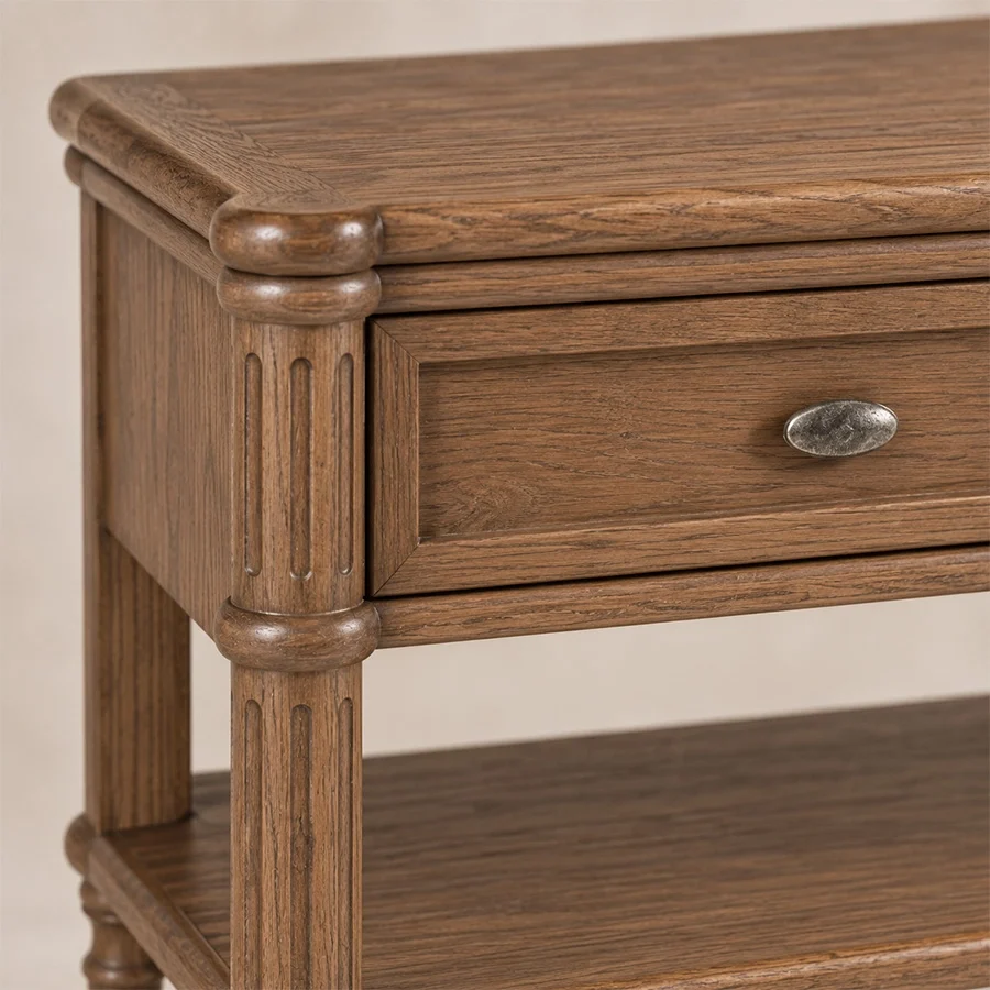 Aldren Platform Bed sidetable zoom view Close-up of Aldren wooden bedside table showing framed drawer, carved detailing, metal knob, and warm brown finish.