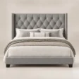 Bellmere Wingback Bed in grey upholstery with diamond-tufted headboard and nailhead trim, front view.