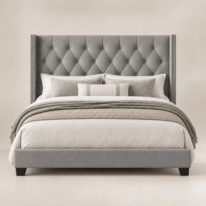 Bellmere Wingback Bed in grey upholstery with diamond-tufted headboard and nailhead trim, front view.