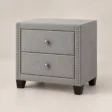 Bellmere Wingback Bedside Table in grey upholstery with two drawers and silver nailhead trim.