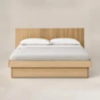 Front view of Caldrin Fluted Bed in Natural Sheesham finish with a vertical fluted headboard and clean wooden frame.