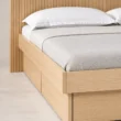 Close-up of Caldrin Fluted Bed in Natural Sheesham finish showing the wooden frame and fluted headboard detail.