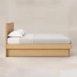 Side view of Caldrin Fluted Bed in Natural Sheesham finish with a clean wooden platform frame.